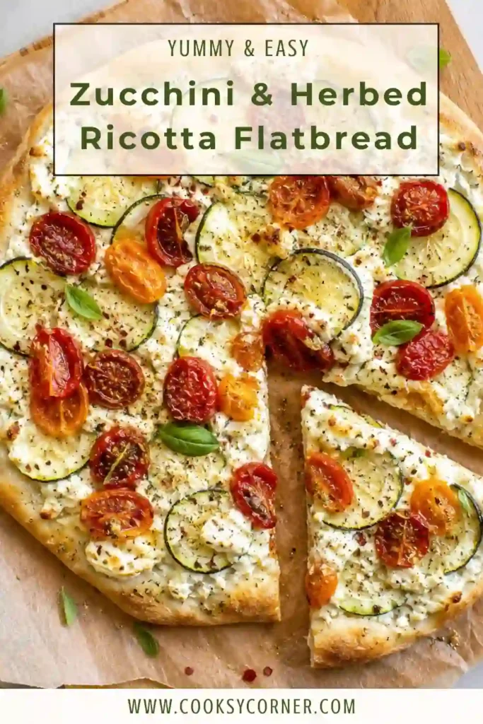 A freshly baked zucchini flatbread with creamy ricotta, blistered cherry tomatoes, goat cheese, and basil on a rustic serving board. This easy vegetarian recipe is colorful and flavorful.