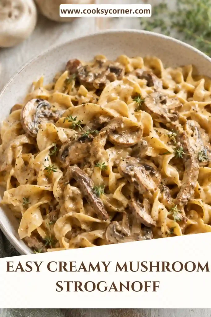 Close-up of creamy mushroom pasta featuring golden sautéed mushrooms and wide egg noodles coated in a velvety stroganoff sauce. A cozy and satisfying meatless dinner.