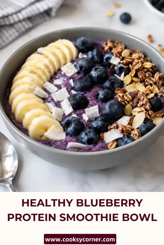Healthy Blueberry Protein Smoothie Bowl featuring frozen berries, yogurt, and vanilla protein powder. Finished with fresh blueberries and sliced banana for a nutritious breakfast.