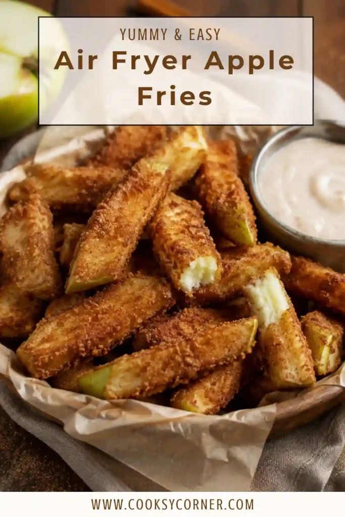 Crispy apple fries made with Granny Smith apples, apple pie spice, and cinnamon sugar. A small bowl of vanilla icing sits alongside the warm air fryer dessert.