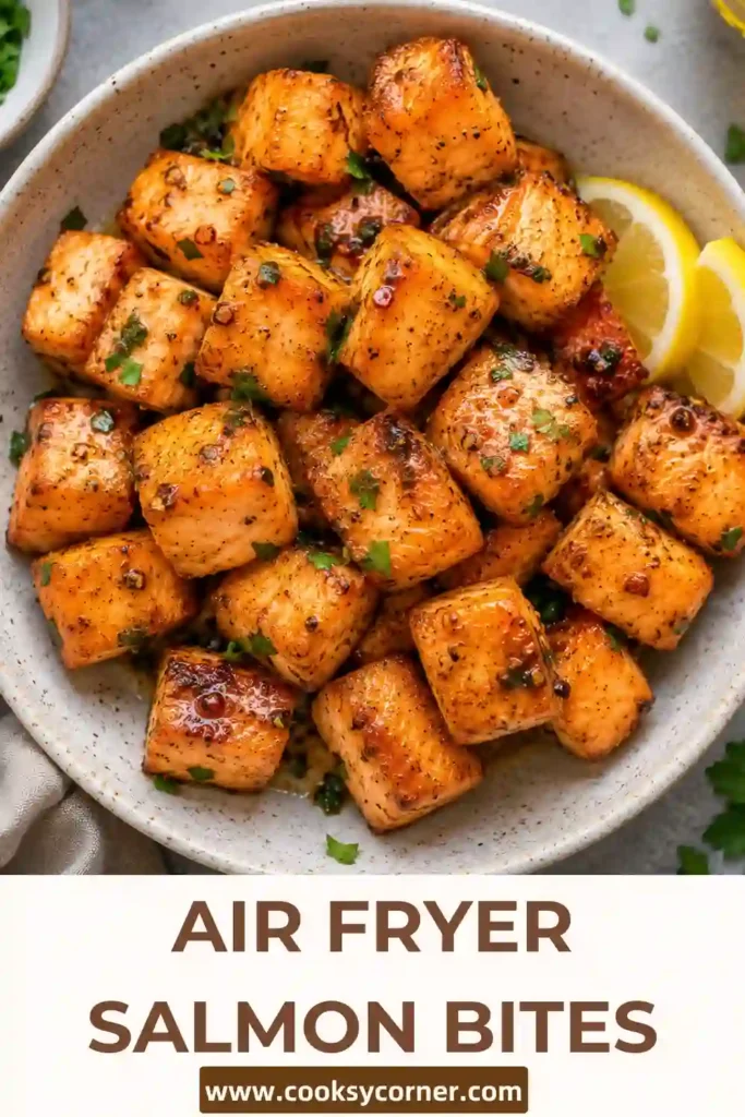 Golden Air Fryer Salmon Bites coated in a honey garlic marinade and served with spicy bang bang sauce. This easy air fryer salmon recipe creates tender salmon with crisp browned edges.