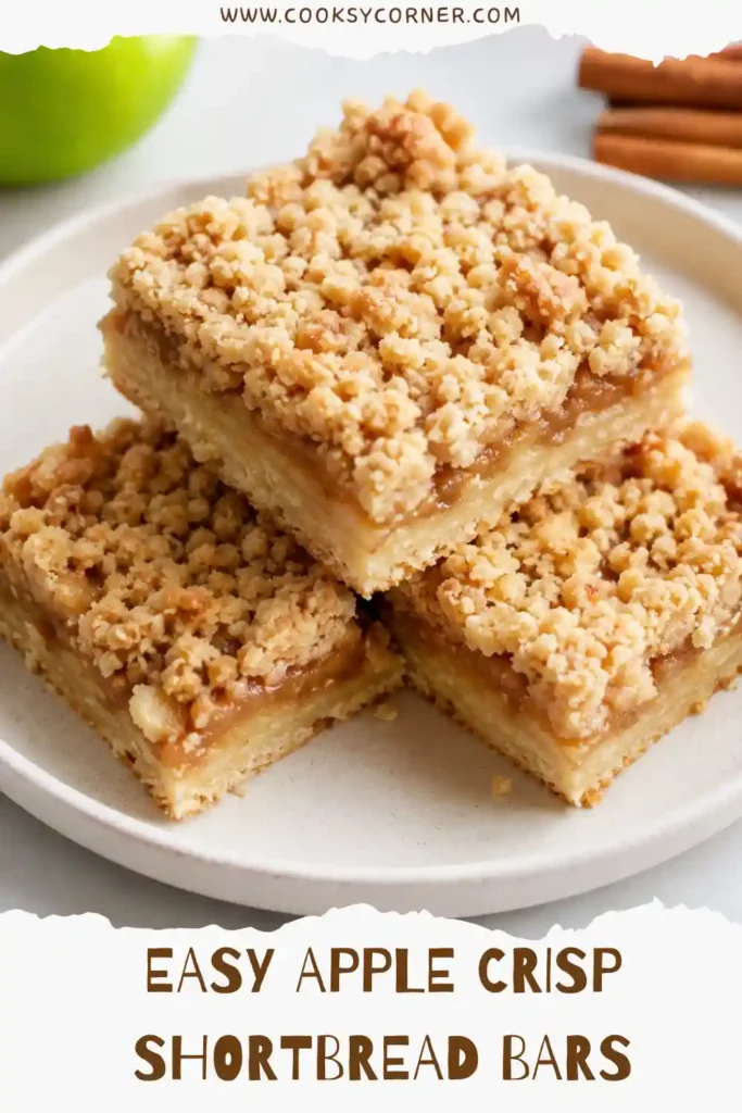 Homemade Apple Crisp Shortbread Bars cut into squares with tender cinnamon apples over a buttery shortbread crust. A golden brown crumble topping adds texture to these easy apple dessert bars.