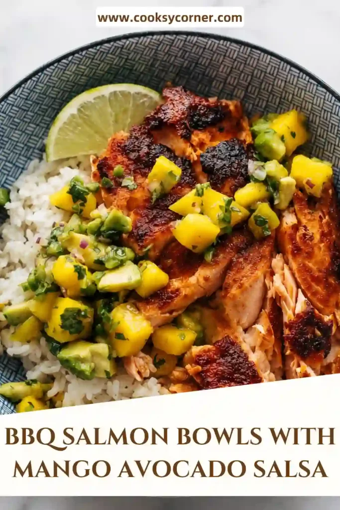 BBQ salmon bowl filled with tender seasoned salmon, fluffy rice, juicy mango, and creamy avocado. Fresh cilantro, red onion, jalapeño, and lime complete the vibrant salsa.