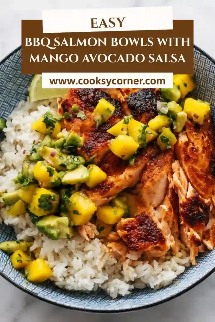 BBQ Salmon Bowls with Mango Avocado Salsa featuring smoky baked salmon over fluffy rice. Fresh mango, creamy avocado, cilantro, red onion, and lime create a colorful topping.