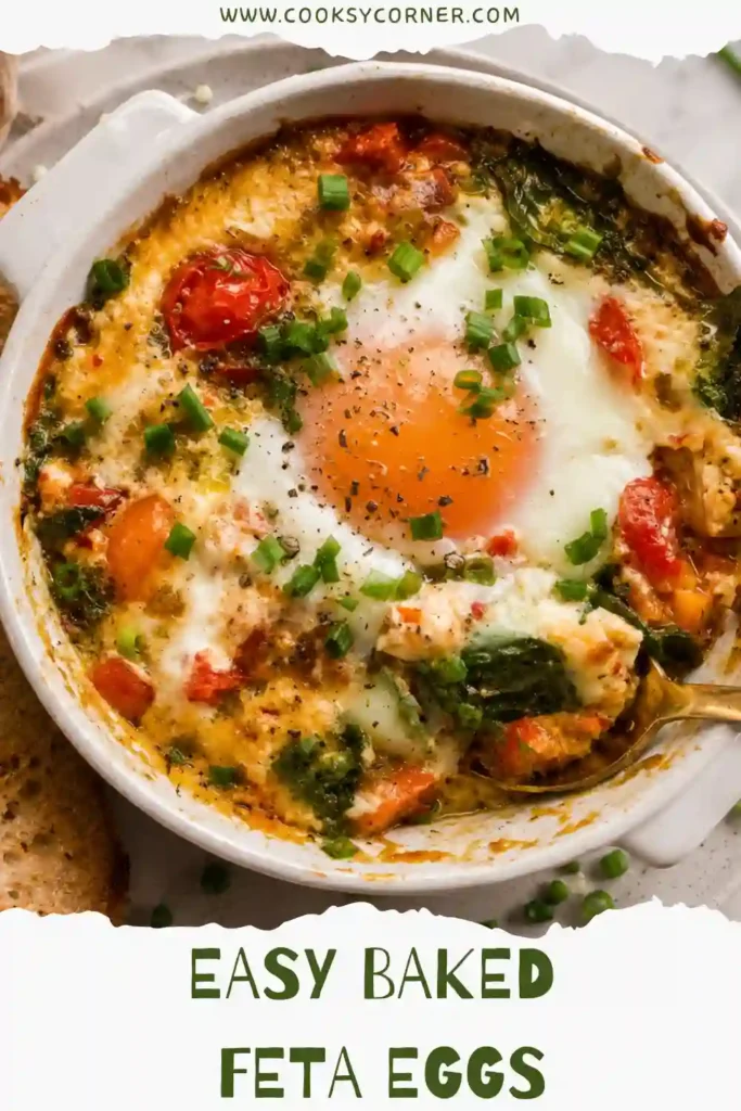 Mediterranean Baked Feta Eggs served warm with juicy tomatoes, spinach, peppers, and herbs. Creamy feta surrounds the tender baked eggs for a hearty breakfast.