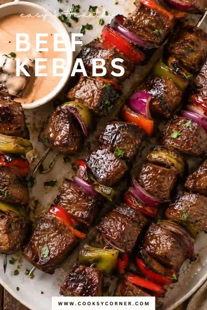 A serving platter filled with grilled Beef Kebabs alongside fresh parsley and dipping sauce.