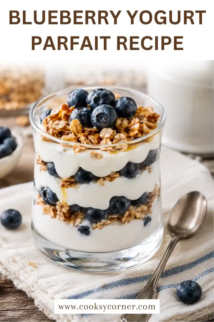 Homemade Greek yogurt parfait with blueberries and crunchy granola served in a clear glass.