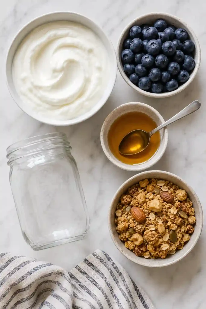 Fresh blueberry parfait layered with creamy yogurt and granola for a healthy breakfast or snack.