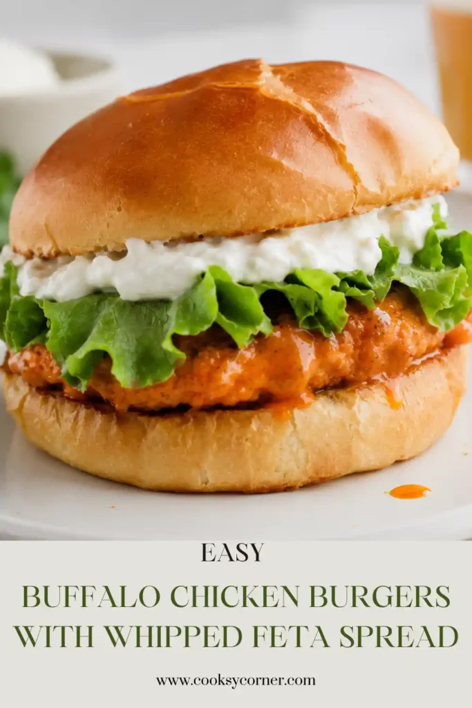 Buffalo Chicken Burgers made with juicy ground chicken patties coated in spicy buffalo sauce. Each burger is served on a soft bun with crisp lettuce and creamy whipped feta spread.
