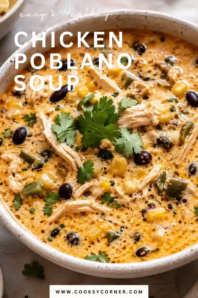 Close-up of creamy Chicken Poblano Soup garnished with cilantro and served in a rustic bowl. The soup features shredded chicken, black beans, corn, and poblano peppers in a creamy broth.