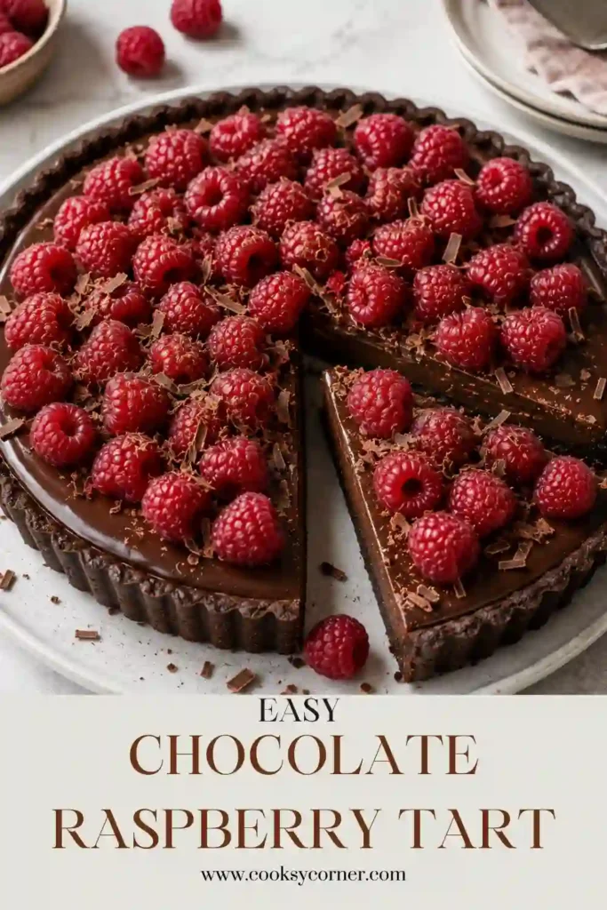 Chocolate Raspberry Tart with smooth chocolate ganache in a crisp Oreo cookie crust. Fresh raspberries cover the top for a colorful and elegant chocolate dessert.