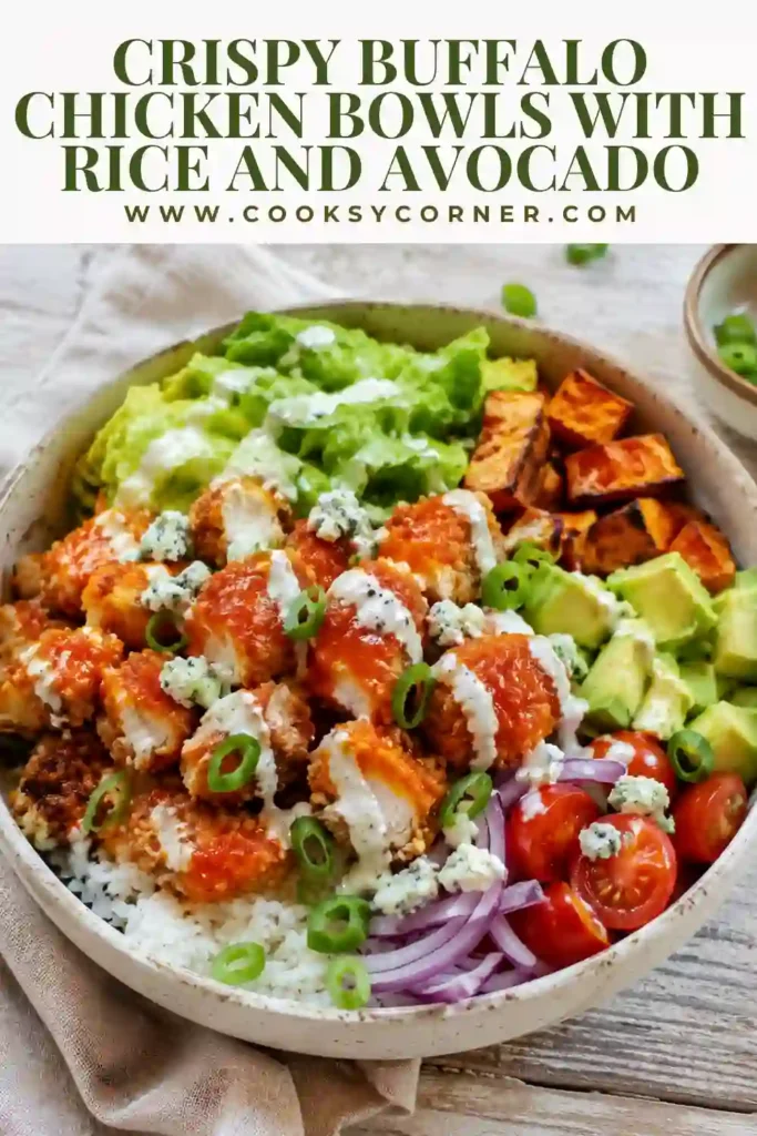 Crispy Buffalo Chicken Bowls with golden spicy chicken served over jasmine rice with carrots, celery, avocado, and green onions. The colorful bowl is finished with creamy dressing and buffalo sauce.