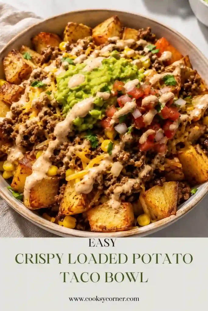 Crispy Loaded Potato Taco Bowl with golden roasted potato chunks, seasoned ground beef, corn, shredded cheddar, guacamole, pico de gallo, and sour cream. A colorful ground beef taco bowl served fresh and ready to eat.