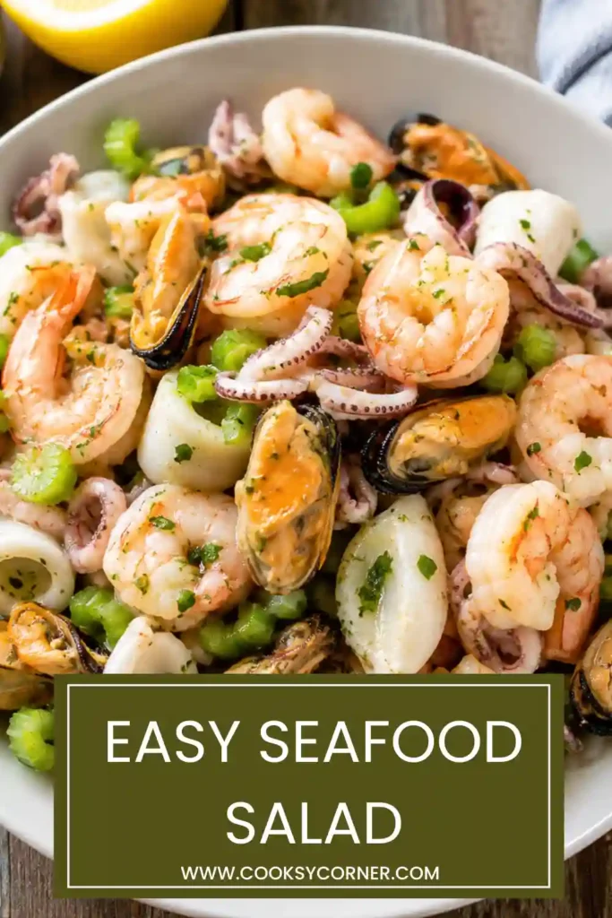 Easy Seafood Salad served on a platter with shrimp, mussels, calamari, lemon slices, and chopped parsley.