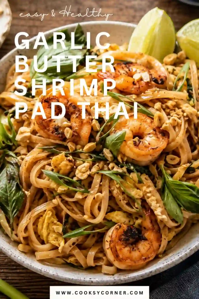 Better Than Takeout Garlic Butter Shrimp Pad Thai served with jumbo shrimp, rice noodles, bean sprouts, peanuts, basil, and lime wedges.