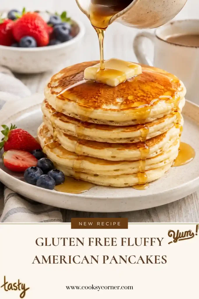 A stack of Gluten-Free Fluffy American Pancakes topped with maple syrup and fresh berries on a breakfast plate. The pancakes are golden, soft, and perfectly fluffy for a delicious gluten-free breakfast.