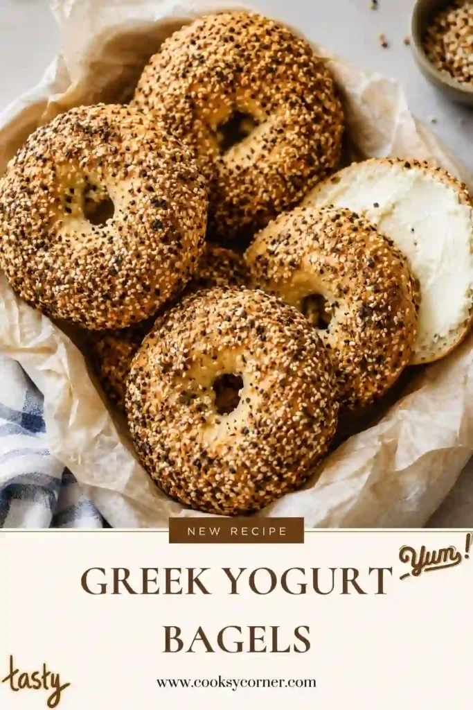 Freshly baked Greek Yogurt Bagels topped with everything bagel seasoning on a parchment-lined baking sheet. These homemade no-yeast bagels have a golden crust and soft, chewy interior.