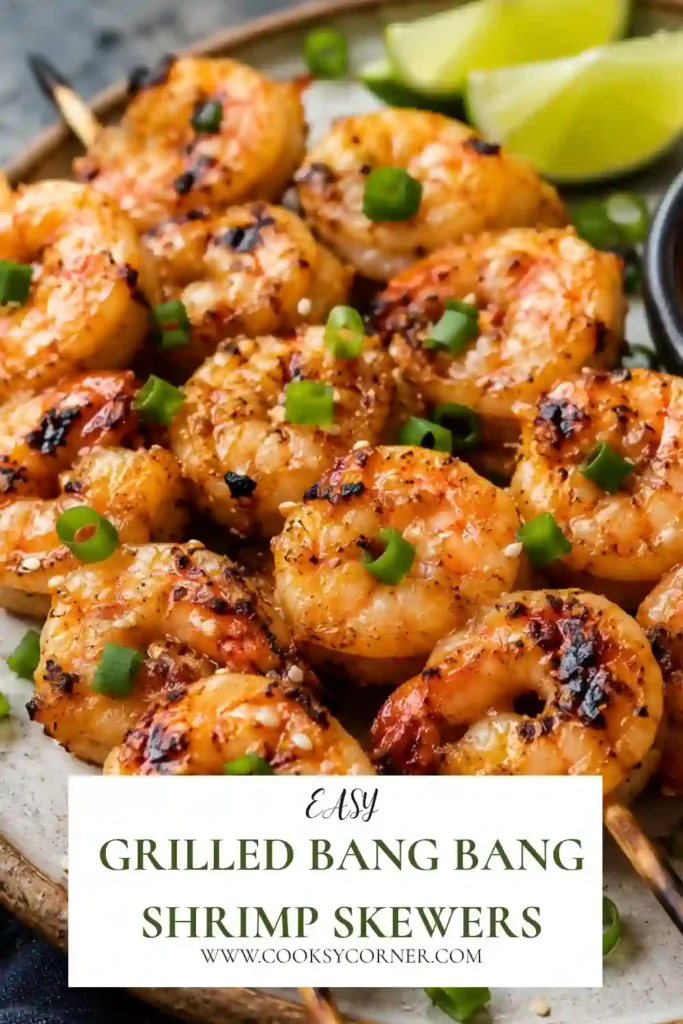 Grilled Bang Bang Shrimp Skewers covered in creamy sweet and spicy bang bang sauce and garnished with sliced scallions. The grilled shrimp have lightly charred edges and a juicy texture.