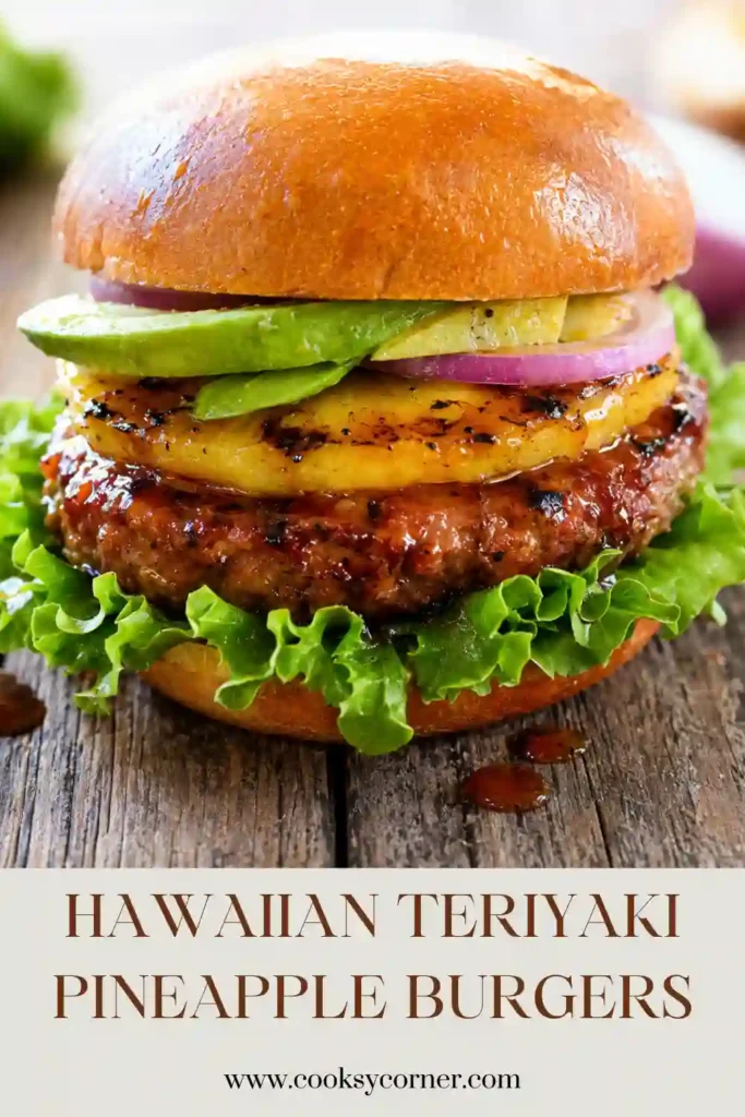 Hawaiian beef burger layered with grilled pineapple, fresh tomato, crisp lettuce, and sweet savory teriyaki sauce. Caramelized grill marks are visible on the pineapple and burger patty.