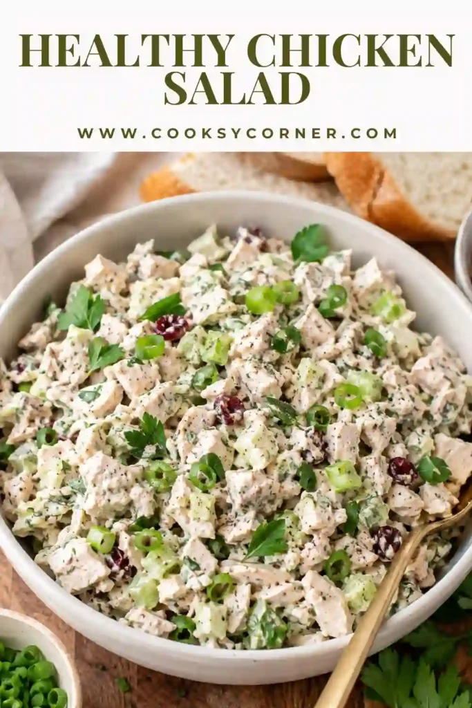 Close-up of Healthy Chicken Salad served with lettuce leaves and crackers. The salad features shredded chicken, fresh herbs, toasted almonds, and a creamy yogurt dressing.