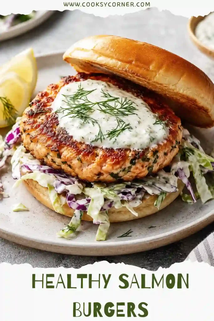 Golden pan-fried salmon patties resting on creamy cabbage slaw garnished with chopped parsley and lemon. This healthy salmon burger recipe is light yet filling.