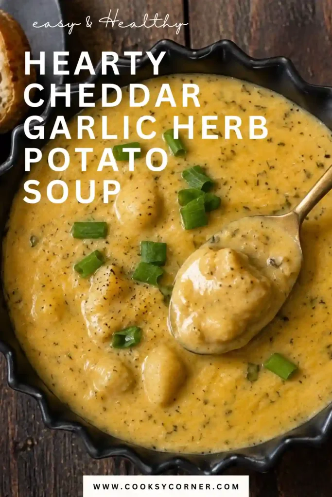 Homemade garlic herb potato soup with tender potatoes and kale in a creamy cheddar broth. Freshly grated cheese and herbs finish the comforting bowl of soup.