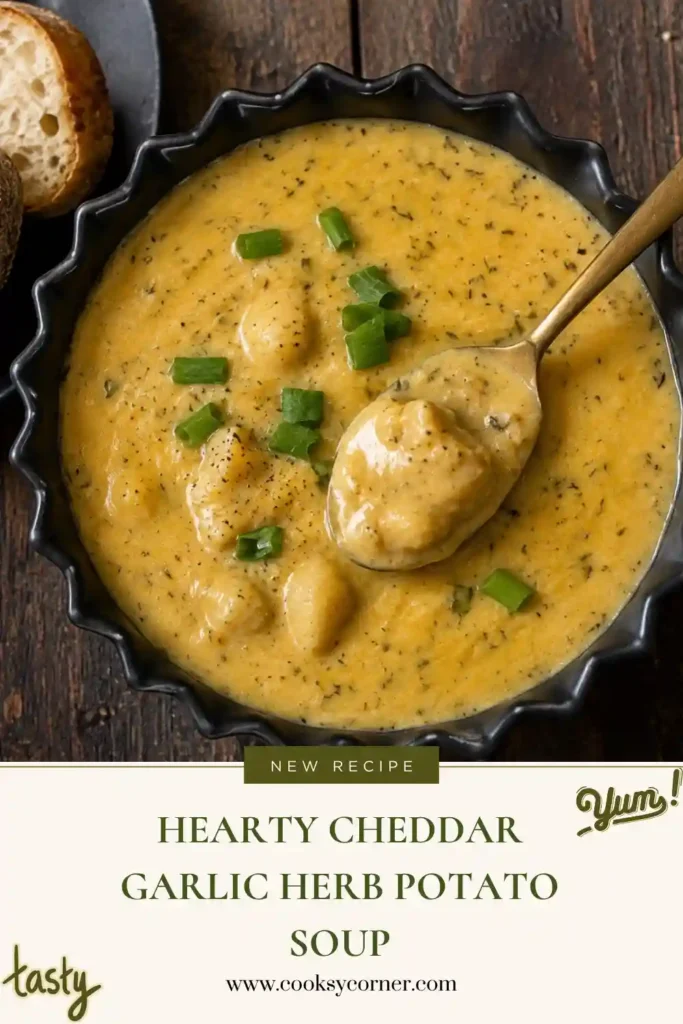 Hearty Cheddar Garlic Herb Potato Soup filled with tender potato chunks in a thick, creamy cheddar broth. Fresh herbs and sliced green onions add color to the rich homemade soup.