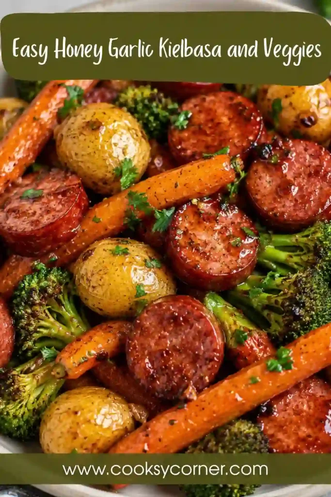 Sheet pan sausage and vegetables with sliced kielbasa, tender baby potatoes, roasted broccoli, carrots, and bell peppers. The colorful dinner is finished with fresh herbs and honey garlic sauce.