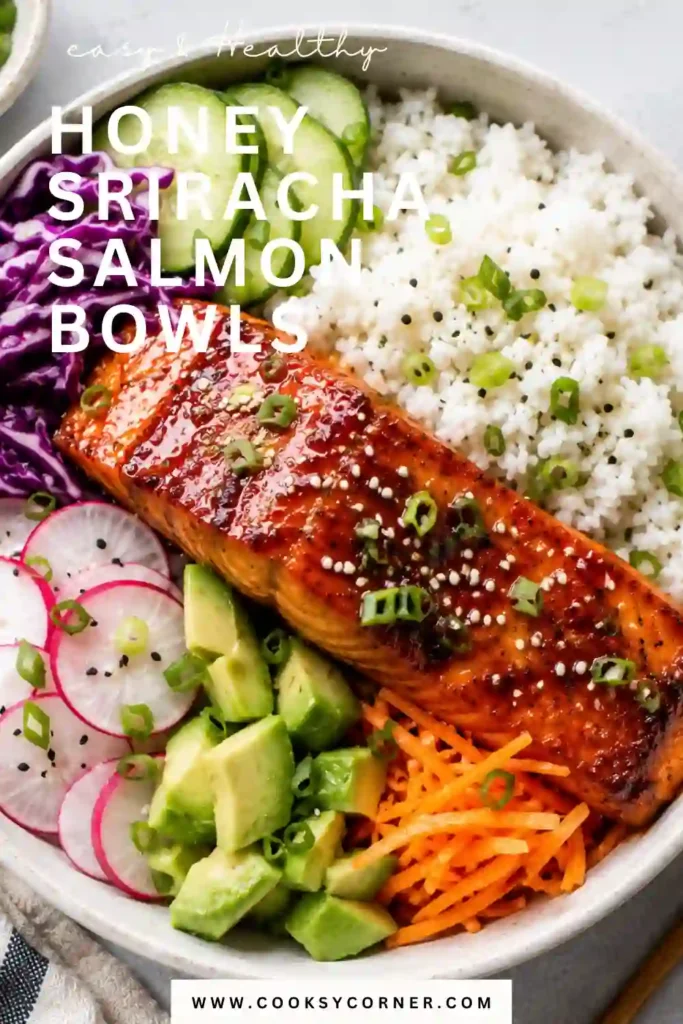 A homemade honey sriracha salmon bowl filled with sticky sweet and spicy salmon, fluffy rice, avocado, cucumber, and green edamame. The salmon is topped with creamy sriracha mayo and sesame seeds.