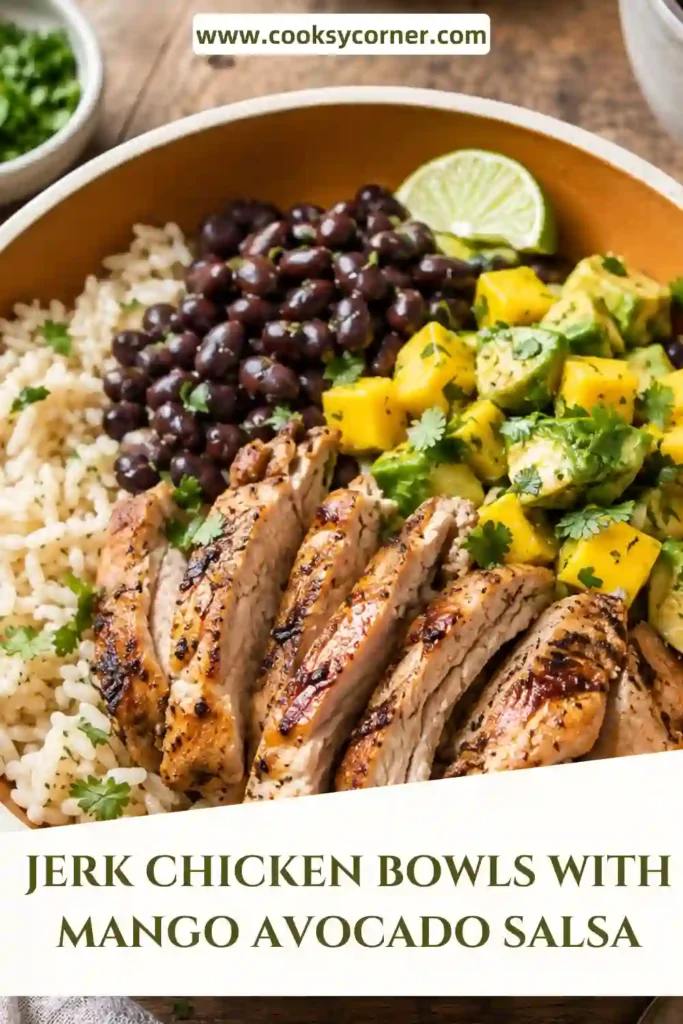 Meal prep jerk chicken bowls topped with juicy chicken, creamy avocado, sweet mango, black beans, and cilantro served in rustic bowls.