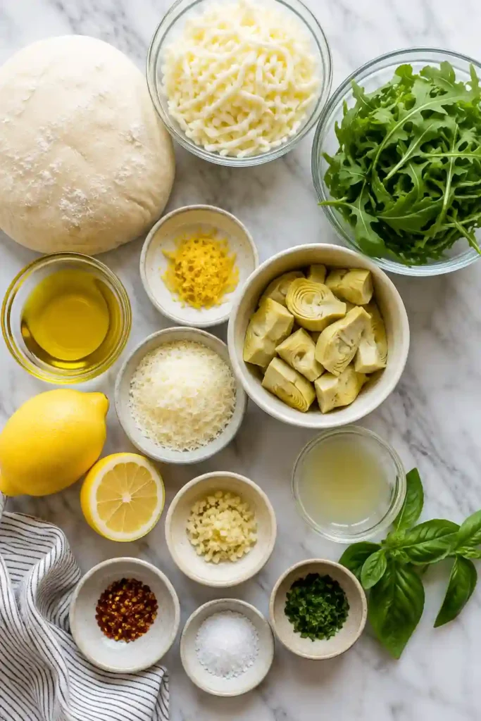 Slices of Lemon Artichoke Arugula Pizza with golden crust, melted cheese, artichokes, fresh greens, and Parmesan. Lemon and garlic give this vegetarian pizza a fresh, savory flavor.