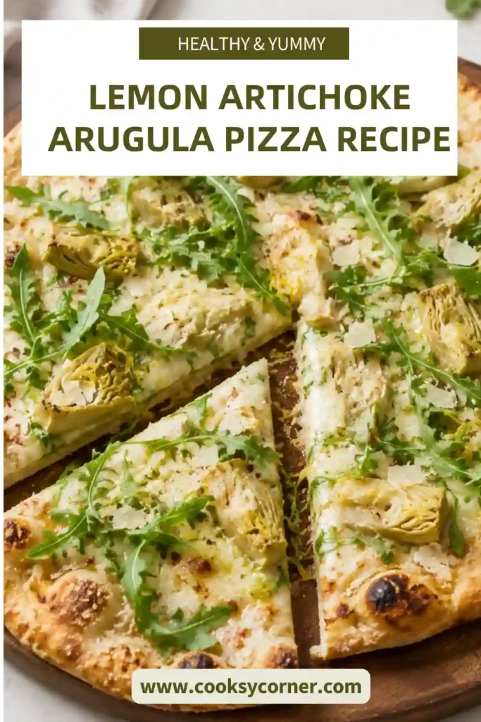 Lemon Artichoke Arugula Pizza topped with melted mozzarella, tender artichoke hearts, fresh baby arugula, and Parmesan. Fresh lemon adds a bright finish to the golden homemade pizza.
