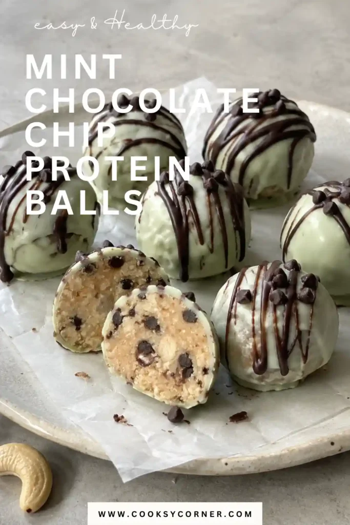 Mint Chocolate Chip Protein Balls served chilled with green chocolate shells and mini chocolate chips. One protein ball is cut open to reveal the soft cashew and chocolate chip center.