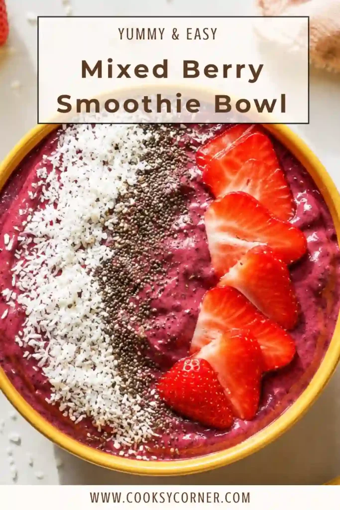 Healthy breakfast smoothie bowl blended with frozen mixed berries, banana, and almond milk. Finished with coconut, seeds, and fresh fruit for extra texture and nutrition.