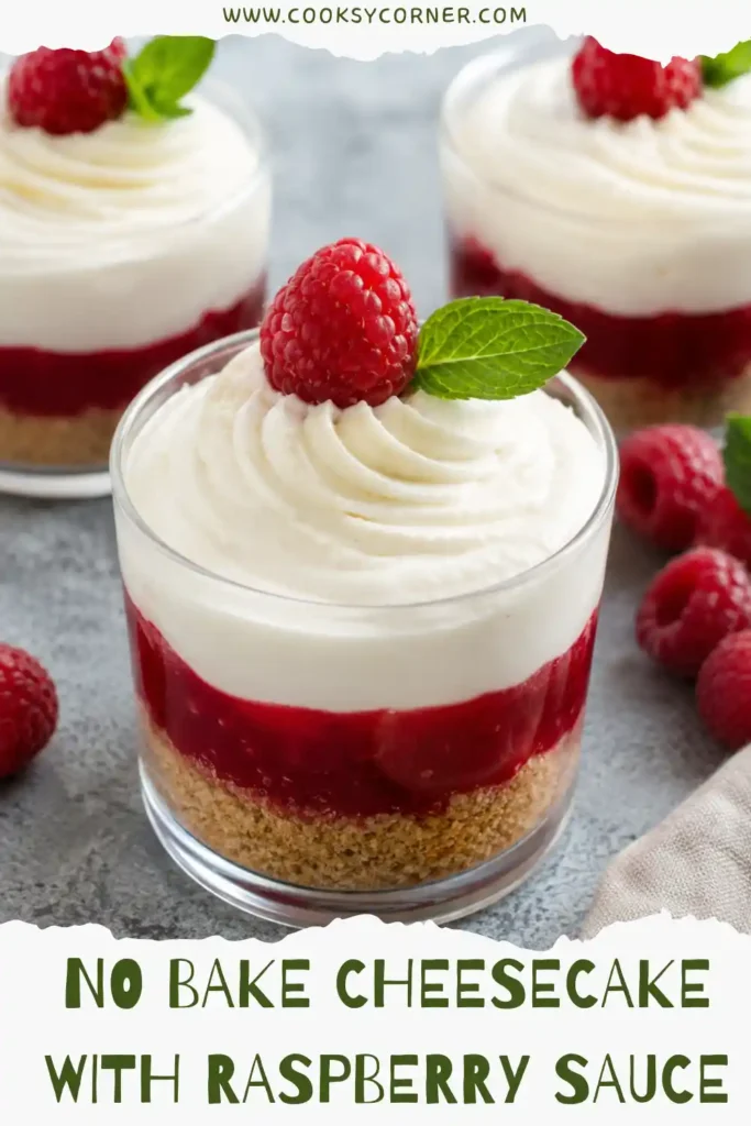 Creamy no bake raspberry cheesecake dessert with smooth berry sauce and golden graham cracker crumbs. Individual cheesecake cups highlight the contrasting red, cream, and golden layers.
