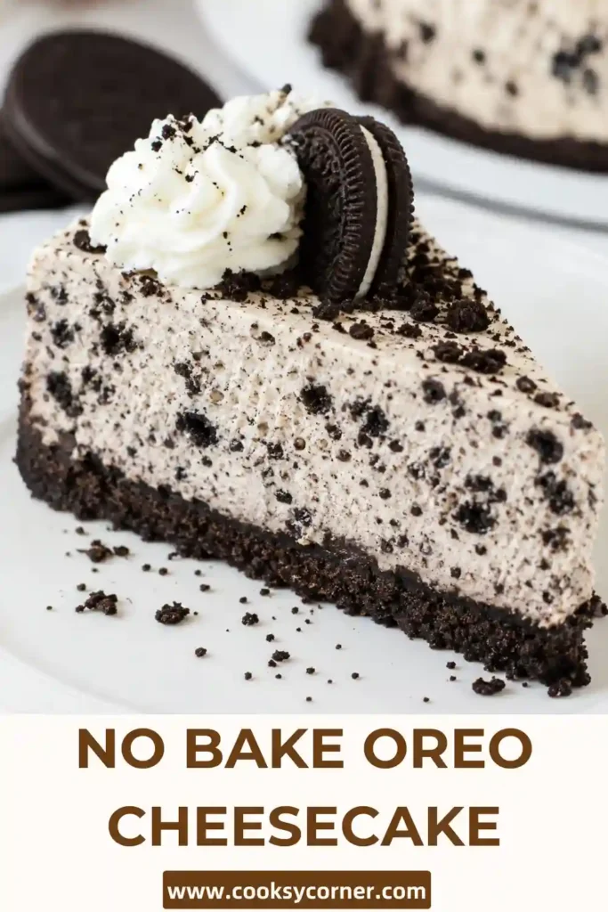 A slice of No Bake Oreo Cheesecake showing a crunchy Oreo crust and creamy filling packed with crushed chocolate cookies. Whipped cream and Oreo halves decorate the top.