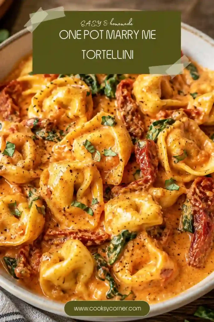 Close-up of creamy sun-dried tomato tortellini with Parmesan, fresh basil, garlic, and chili flakes. This one pot tortellini has a rich, velvety sauce surrounding tender cheese-filled pasta.