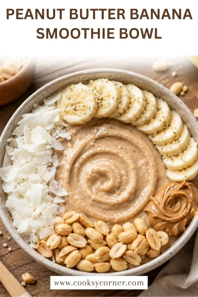 A Peanut Butter Banana Smoothie Bowl served with fresh bananas, chopped peanuts, granola, and hemp hearts on a light wooden table.