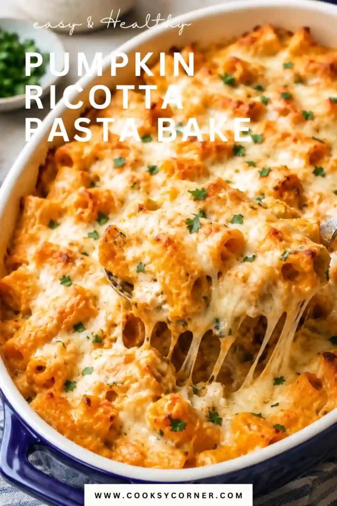 Creamy Pumpkin Ricotta Pasta Bake topped with melted mozzarella and Parmesan in a casserole dish. This cheesy pumpkin pasta bake combines tender pasta, spinach and savory pumpkin sauce.