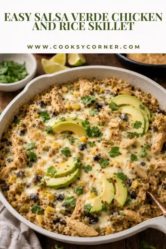 One pan Salsa Verde Chicken and Rice Skillet made with shredded chicken, white rice, green chiles, corn, black beans, and cheese. Fresh avocado and cilantro add a colorful finish to the savory skillet meal.