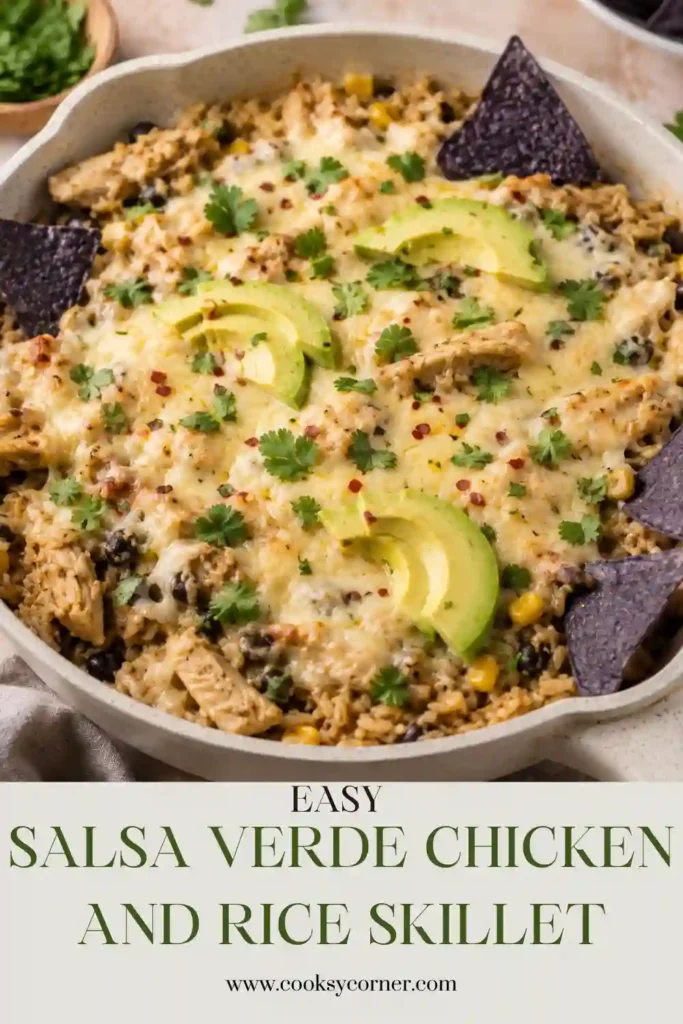 Salsa Verde Chicken and Rice Skillet topped with melted Monterey Jack cheese, fresh cilantro, and sliced avocado. This one-pan chicken and rice dinner includes black beans, corn, green chiles, and tangy salsa verde.