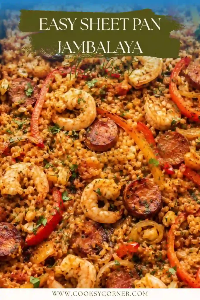 Close-up of a low carb Cajun recipe featuring tender shrimp, smoky beef sausage, roasted peppers, onions, and fluffy cauliflower rice on a baking sheet.