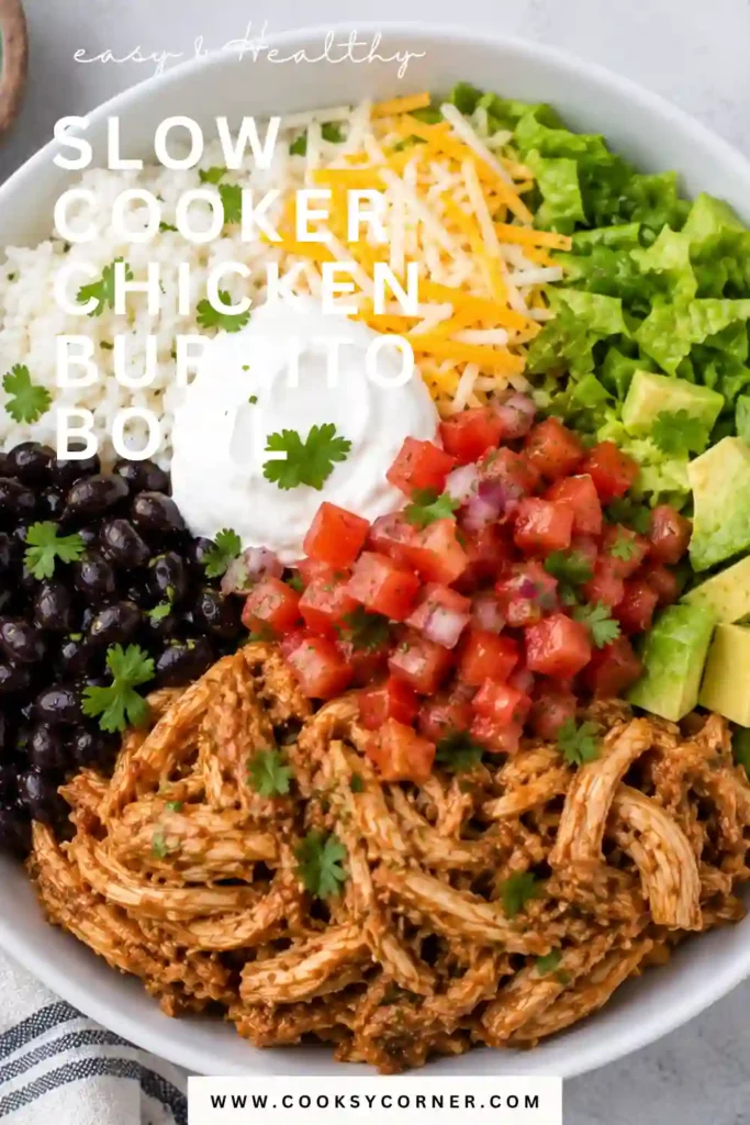 Slow Cooker Chicken Burrito Bowl filled with tender shredded Mexican chicken, fluffy rice, black beans, sweet corn, and creamy diced avocado. Fresh cilantro and lime add a colorful finishing touch.
