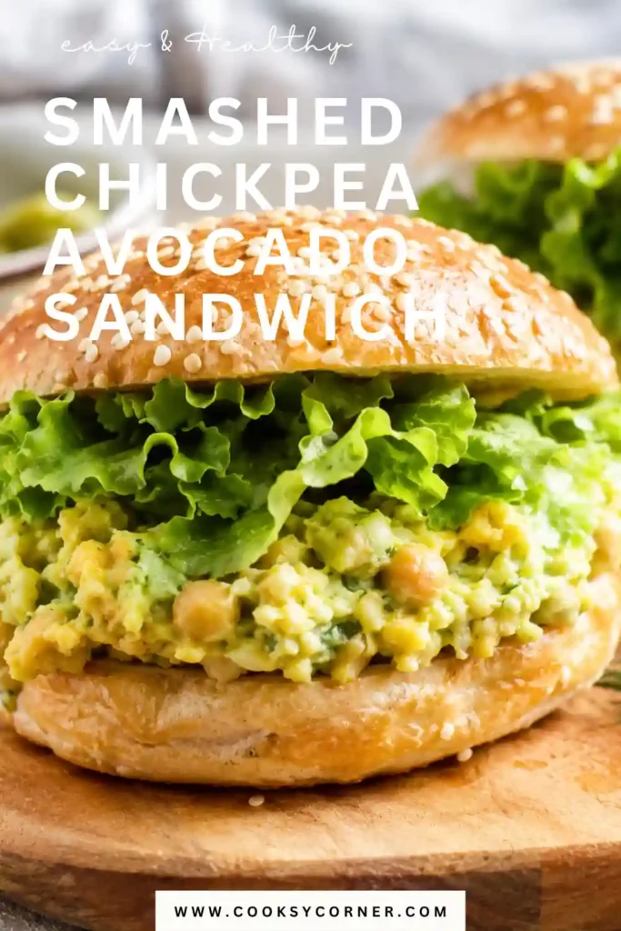 3. Homemade smashed chickpea sandwich with avocado, fresh dill, pickles, and crisp lettuce. The creamy plant-based filling is served between slices of hearty whole grain bread.