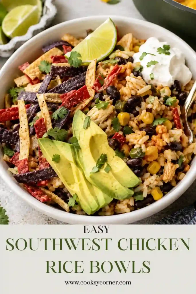 A bowl of Southwest Chicken Rice Bowls filled with seasoned chicken, fluffy basmati rice, black beans, sweet corn, colorful peppers, melted cheese, fresh cilantro, and lime wedges. This easy one-pan chicken and rice bowl is hearty, vibrant, and perfect for weeknight dinners.