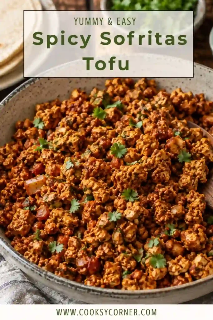 Close-up of spicy sofritas tofu tucked inside warm tortillas with avocado, cilantro, onions, and fresh lime wedges. A colorful and satisfying vegan taco filling.