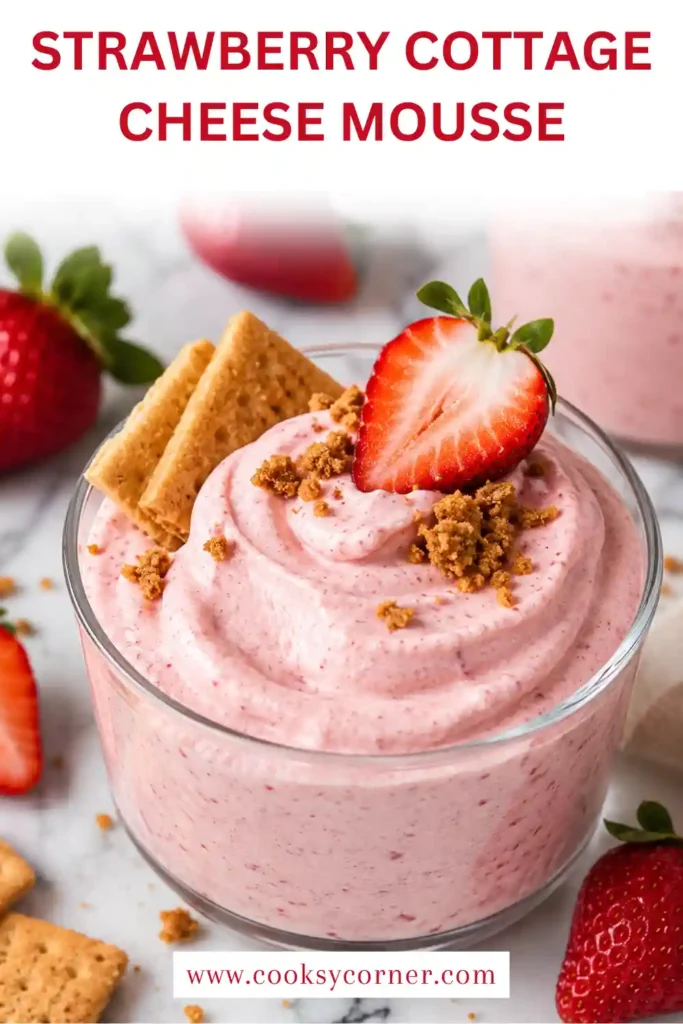 Creamy Strawberry Cottage Cheese Mousse served in a glass with fresh strawberry slices. This easy strawberry dessert has a smooth pink texture and fresh berry topping.