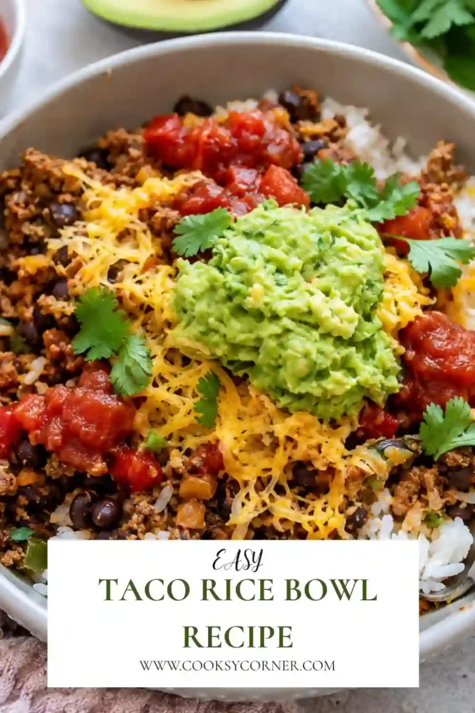Fresh Tex-Mex taco bowl featuring seasoned beef, white rice, black beans, creamy avocado, cheddar cheese, and salsa. A colorful and flavorful meal that's simple to prepare.