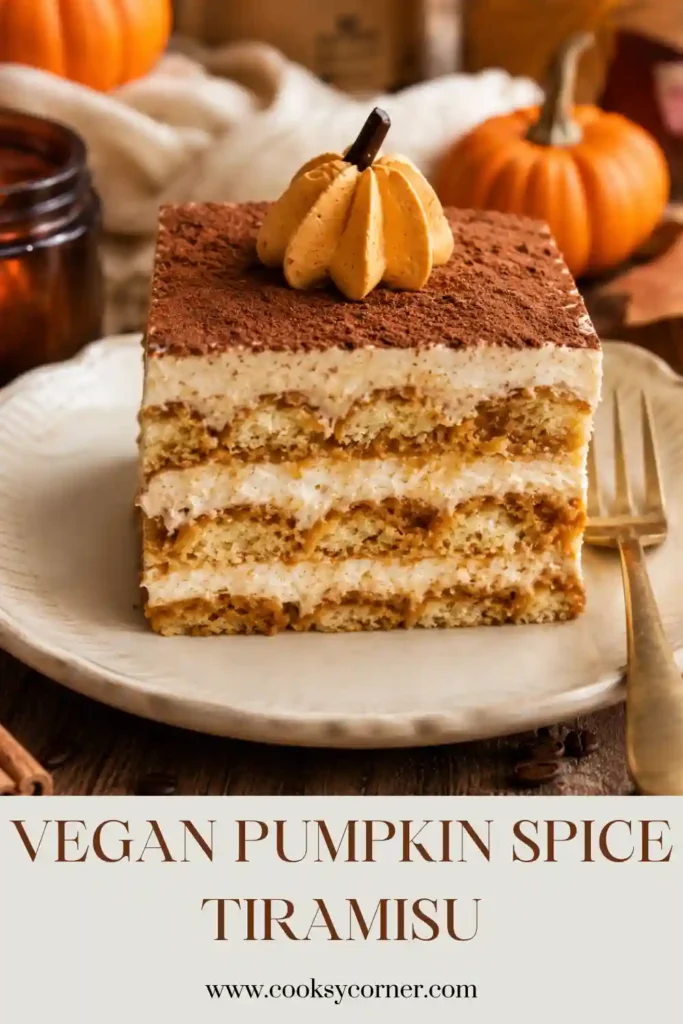 Dairy-free pumpkin tiramisu layered with vegan ladyfingers, espresso, pumpkin spice cream, and cocoa. Small orange cream pumpkins decorate the top of the chilled fall dessert.