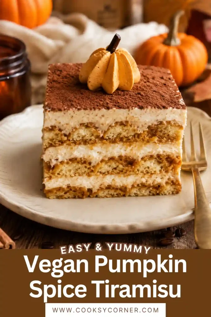 Vegan Pumpkin Spice Tiramisu with layers of coffee-dipped ladyfingers and creamy pumpkin spice filling. The dairy-free dessert is finished with whipped cream, cocoa powder, and decorative pumpkin-shaped cream.